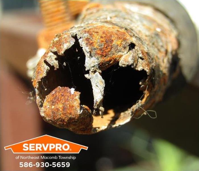 An old corroded pipe is shown.